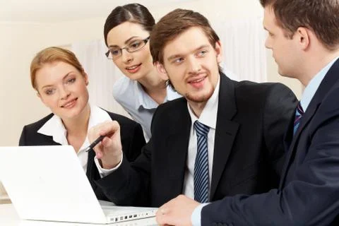 Portrait of friendly workteam discussing project while confident businessman poi Stock Photos