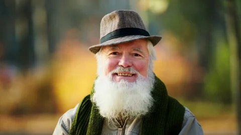 Portrait in front of the camera of a charismatic old man posing in front of the Stock Footage 166644230