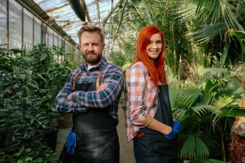 Portrait in front of the camera good looking two gardener standing in front of Stock Photos