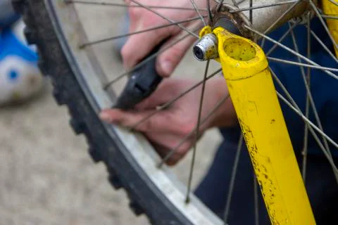 A portrait of the front fork and wheel of a bicycle with in the blurred backg Foto stock