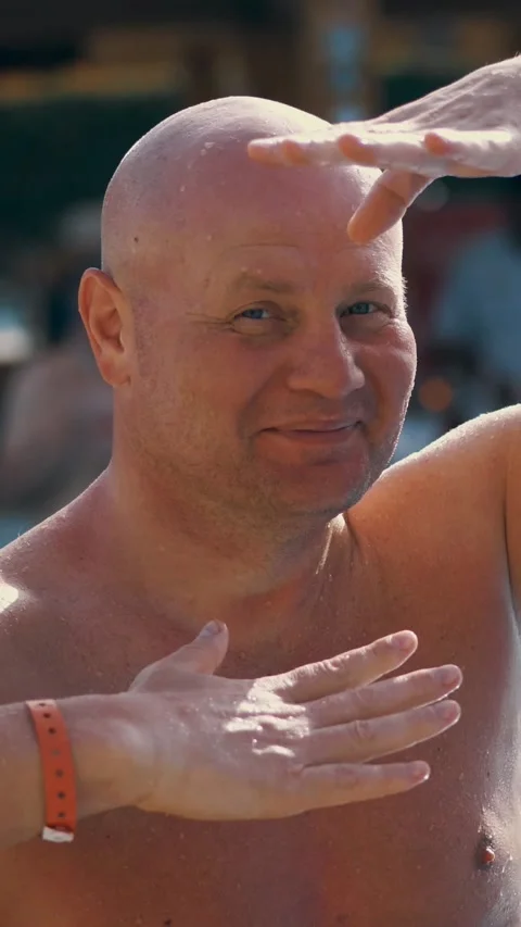 Portrait, funny bald middle-aged man, with a naked torso, something fun sings, Stock Footage 311990111