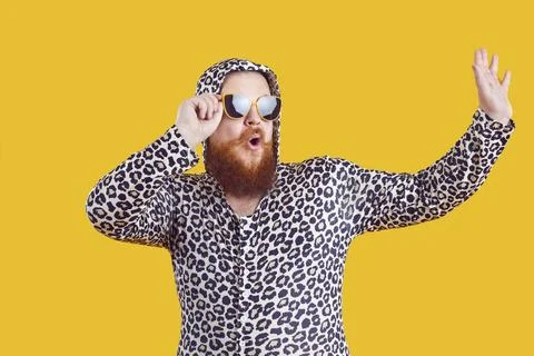 Portrait of funny comic chubby man who is strangely dressed and having fun on 스톡 사진