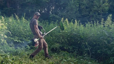Portrait funny garden worker in garden playing the guitar Stock-Footage 330189697