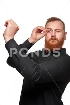 Portrait of a funny positive young man looking through a telescope on white Stock Photos