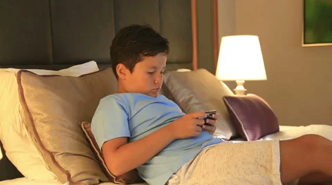 Portrait of a funny young boy playing on smartphone at home 6 Stock-Footage 66262168