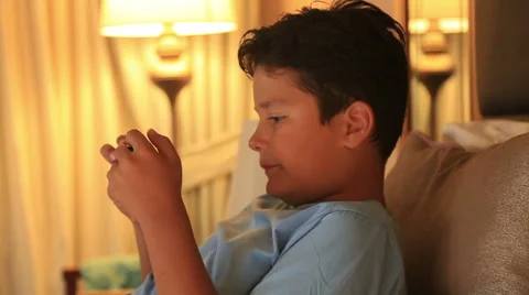 Portrait of a funny young boy playing on smartphone at home 4 Stock Footage 66356899
