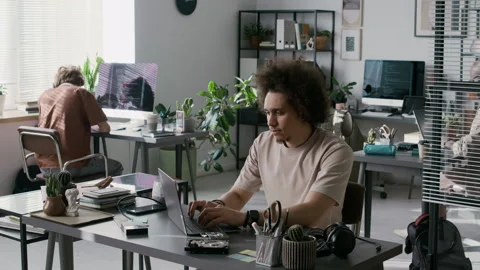Portrait of Gen Z Male Programmer Working on Laptop in Modern Office Stock Footage 299204242