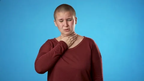 Portrait of gender fluid non binary young hipster woman 20s coughs into hand Stock Footage 223261061