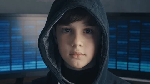 Portrait of a genius boy hacker prodigy in the hood on the background of Vidéo 101993941