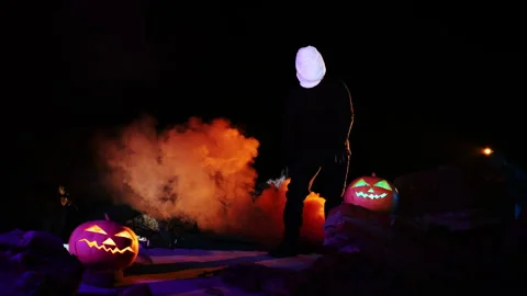 Portrait of a ghost covered with white fabric ribbons in orange smoke. Stock Footage 286087434