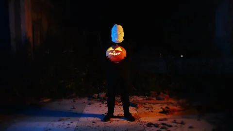 Portrait of a ghost covered with white fabric ribbons in neon light. Stock Footage 286087776