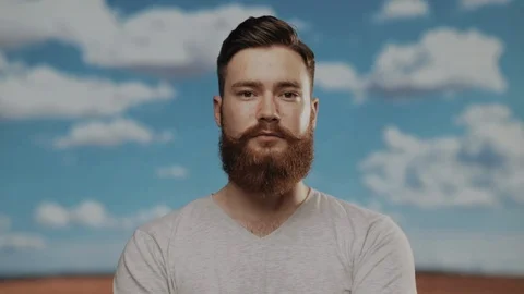 Portrait of a ginger haired man, looking at the camera and neglecting his Stock Footage 110818114
