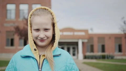 Portrait of a girl on the background of a middle school building in the United Stock Footage 246760335