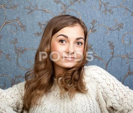Portrait of a girl on a background of retro wallpaper Stock Photos