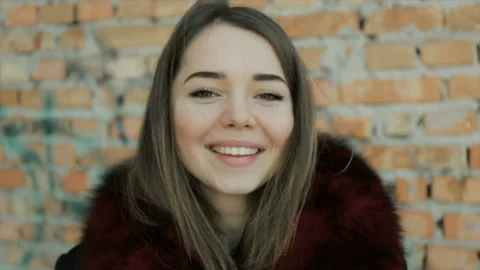 Portrait of a girl on a brick wall background Stock Footage 96277686