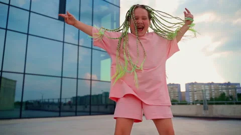 Portrait girl dancing looking at camera outdoors Stock Footage 202220901