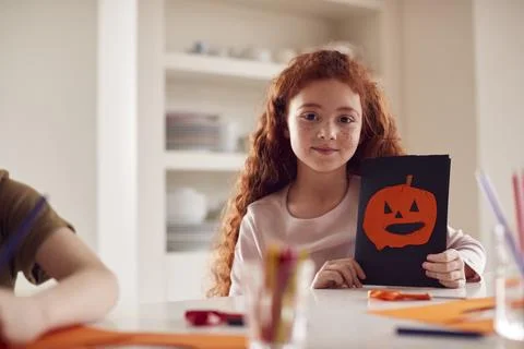 Portrait Of Girl At Home With Friends Having Fun Making Halloween Decorations Stock Photos