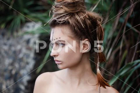 Portrait of girl with painting on her face and careless hairstyle Stock Photos