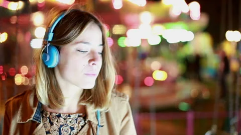 Portrait of girl shaking her head to the rhythm of music with headphones Stock Footage 59556366