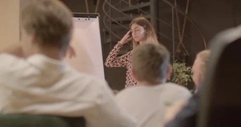 Portrait girl student knowledge sharing at flipchart, discussing tasks at school 動画素材 248865993