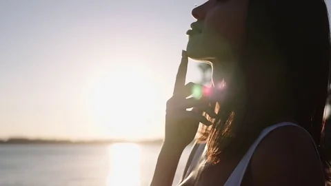 Portrait of a girl at sunset. Silhouette of a girl from the back. Stock Footage