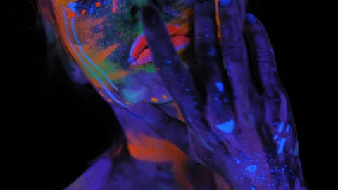 Portrait of a girl with a UV pattern on her face, she slowly moves her head. Stock Footage 266777856