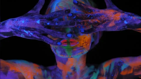 Portrait of a girl with a UV pattern on her face, she slowly moves her head. Stock Footage 268790877