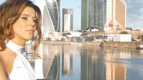 Portrait of a girl in a white suit on the city embankment. Early in the morning. Stock Footage
