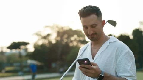Portrait of golfer reading message on phone in sports club Stock Footage 282164113