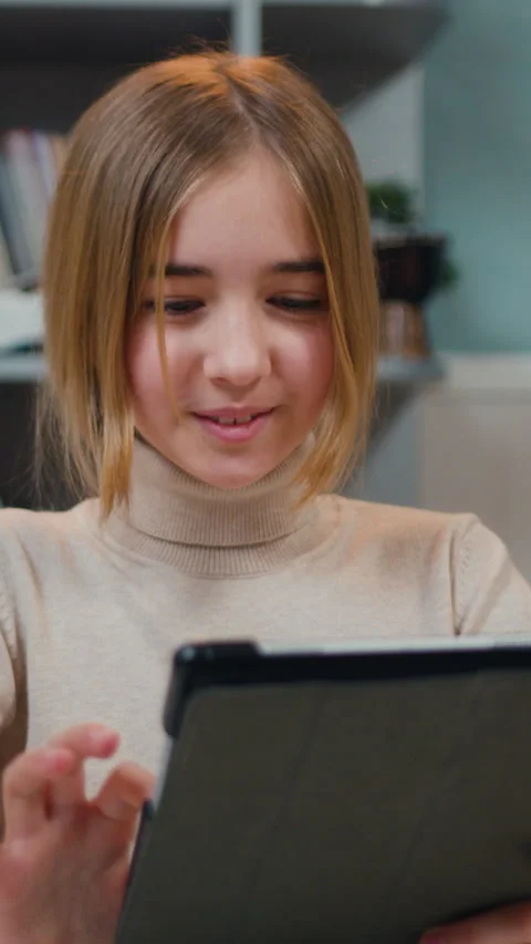 Portrait of good-looking 10s year school girl use tablet device, learning online Stock Footage 330193148