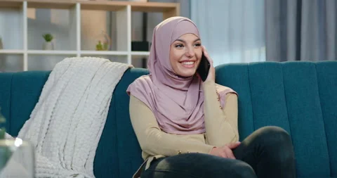 Portrait of good-looking cheerful stylish arabian woman in hijab and sweater and Stock Footage 150123352