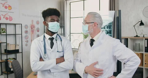 Portrait of good-looking confident skilled different ages mixed race doctors in Stock Footage 160414490
