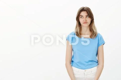 Portrait of good-looking gloomy girlfriend in blue t-shirt, pouting lips and Stock Photos