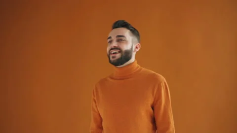 Portrait of good-looking guy looking around then winking at camera smiling Stock Footage 108150022