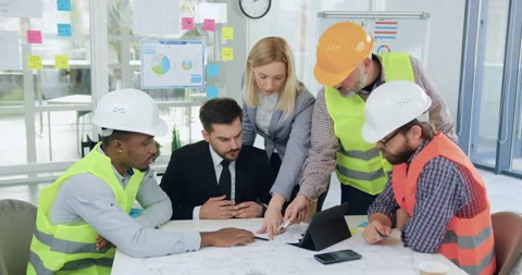 Portrait of good-looking high-skilled purposeful mixed races team of builders in Stock Footage 145803150