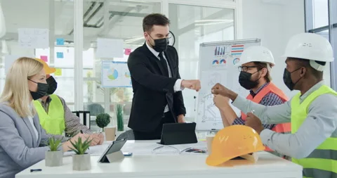 Portrait of good-looking positive bearded manager in protective mask which Stock Footage 145637430