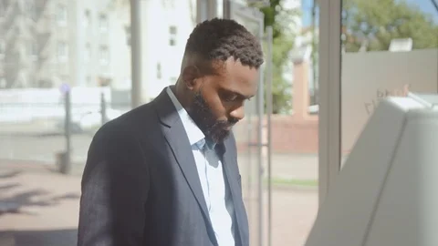Portrait of good-looking prosperous african businessman withdrawing money Stock Footage 110481648