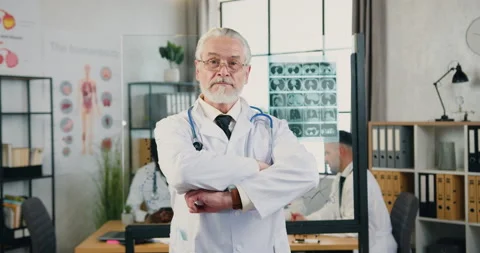 Portrait of good-looking serious experienced respected 65-aged bearded doctor in Stock Footage 160422207