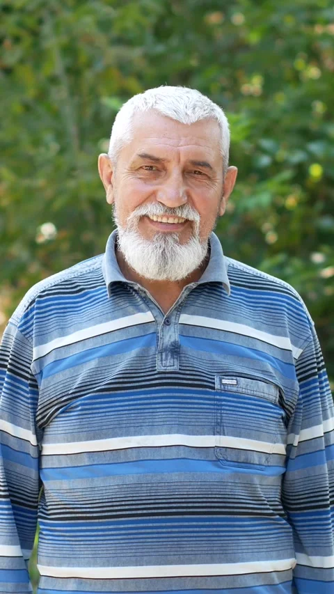 Portrait of a gray-haired old man. handsome smiling grandfather with white Stock Footage 290154269