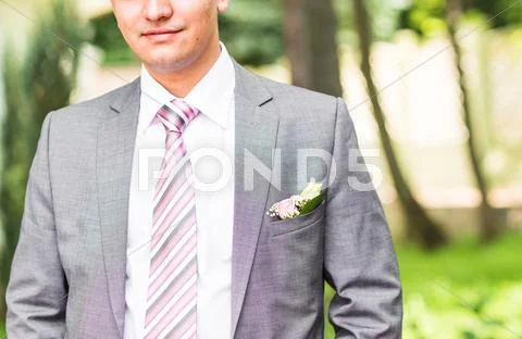 Portrait Of The Groom In A Park On Their Wedding Day