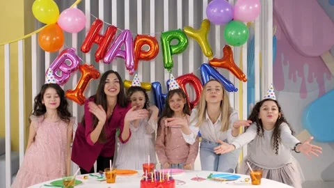 Portrait of a group of children and their mothers celebrating a birthday. Stock Footage 317001076