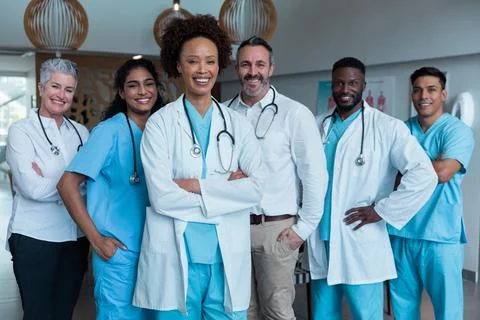 Portrait of group of diverse male and female doctors standing in hospital Stock Photos