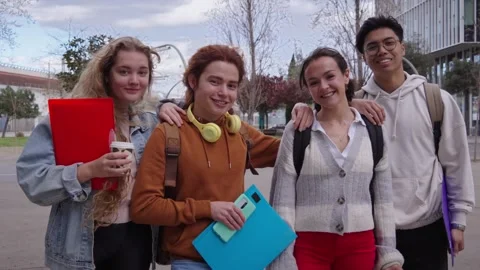 Portrait of a group of four cheerful multi ethnic students having fun outdoors Stock Footage 247798518