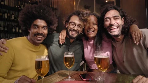 Portrait of group of friends looking at camera in a restaurant bar after work at Stock Footage 224345620