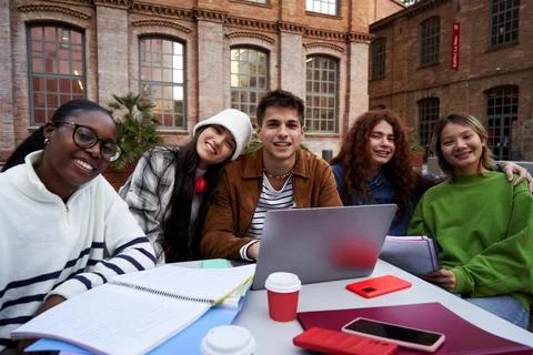 Portrait of a group of students looking at camera outside at university campus Stock Photos