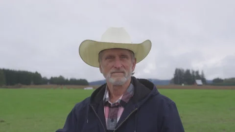 Portrait of a Grumpy Old Farmer in a Field Video stock 208785724