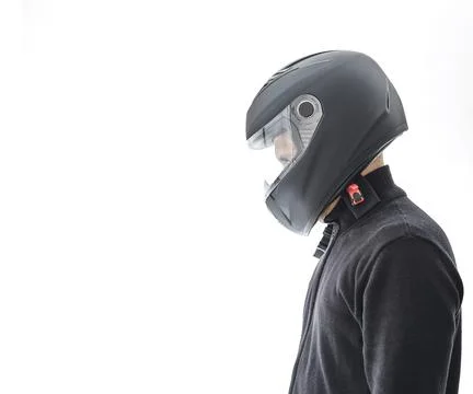 Portrait of guy with black checkered jacket and motorcycle helmet pretending to Stock Photos