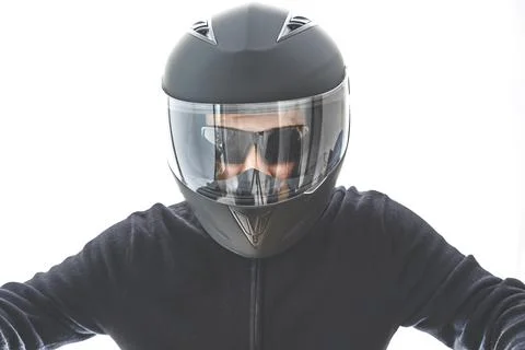 Portrait of guy with black checkered jacket and motorcycle helmet pretending to Stock Photos