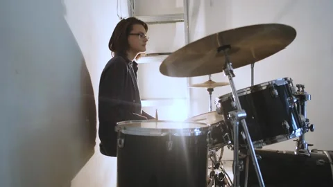 Portrait guy drummer sitting at the drum kit in the light of a lamp Video stock 241083930