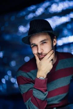 Portrait of a guy in a hat on a blurred background Stock Photos